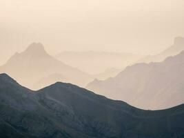 doux rose le coucher du soleil dans Montagne paysage. incroyable rose le coucher du soleil avec une silhouette de montagnes. photo