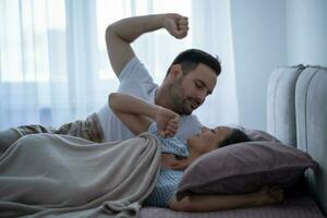 une Jeune couple mensonge dans lit photo