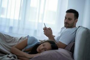 une Jeune couple mensonge dans lit photo