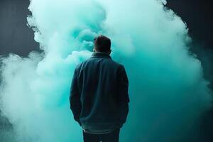 une homme permanent dans de face de une nuage de fumée avec le cyan thème. ai généré photo