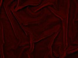 texture de tissu de velours rouge utilisée comme arrière-plan. fond de tissu rouge vide de matière textile douce et lisse. il y a de l'espace pour le texte.. photo