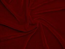 texture de tissu de velours rouge utilisée comme arrière-plan. fond de tissu rouge vide de matière textile douce et lisse. il y a de l'espace pour le texte.. photo