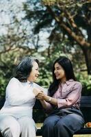 jeune physiothérapeute asiatique travaillant avec une femme âgée sur la marche avec un déambulateur photo