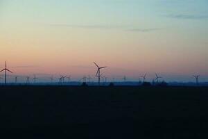 paysage avec le coucher du soleil et vent ferme Moulins à vent après foncé photo