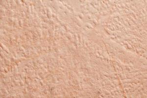 Mur de maison en plâtre rugueux beige clair comme arrière-plan