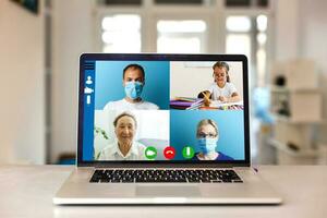 groupe de médecins à la recherche à en ligne présentation sur ordinateur dans hôpital photo