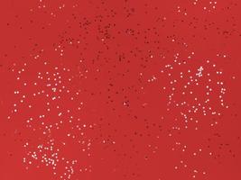 étoiles de confettis sur fond de fête de papier rouge photo