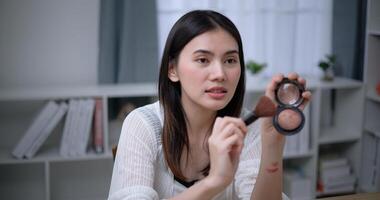 magnifique Jeune asiatique femme blogueur spectacles Comment à faire en haut et utilisation produits de beauté photo