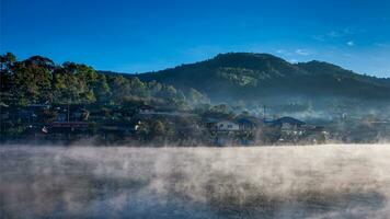 Village de Rakthai avec brouillard du lac le matin à Mae Hong Son, Thaïlande photo