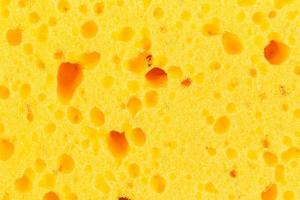 texture abstraite de la surface jaune d'un gant de toilette photo