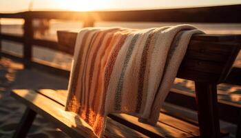 le coucher du soleil table sur pont, rayé serviette empiler généré par ai photo