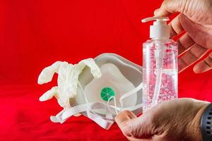 Gel désinfectant mains gants en latex blanc et masque sur le concept de protection rouge contre la grippe virus de la pollution et le coronavirus photo