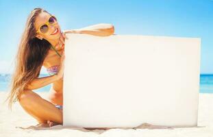 femme sur une plage en portant une Vide planche pour votre texte photo