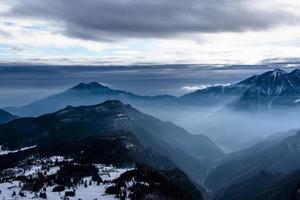 sommets alpins enneigés dans les nuages cinq photo