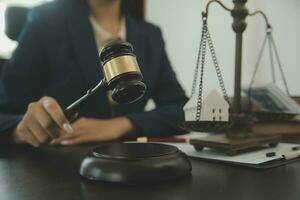 concept de justice et de droit. juge masculin dans une salle d'audience avec le marteau, travaillant avec, clavier d'ordinateur et d'accueil, lunettes, sur table à la lumière du matin photo