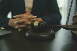 concept de justice et de droit. juge masculin dans une salle d'audience avec le marteau, travaillant avec, clavier d'ordinateur et d'accueil, lunettes, sur table à la lumière du matin photo