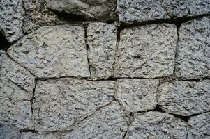 le texture de vieux pierre blocs. maçonnerie des murs de un vieux bâtiment. photo