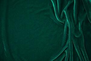 vert velours en tissu texture utilisé comme Contexte. paon Couleur panne en tissu Contexte de doux et lisse textile matériel. écrasé velours .luxe émeraude Ton pour soie. photo