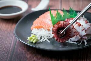 tako sashimi sur baguettes, Japonais nourriture photo