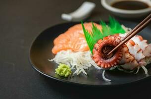 tako sashimi sur baguettes, Japonais nourriture photo