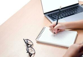 étudiant l'écriture devoirs sur Vide carnet avec portable sur bureau, photo