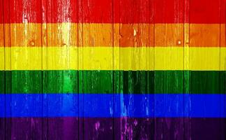 drapeau de le lgbt communauté sur le Contexte de le en bois texture de le planches. arc en ciel gay culture symbole. concept collage. photo