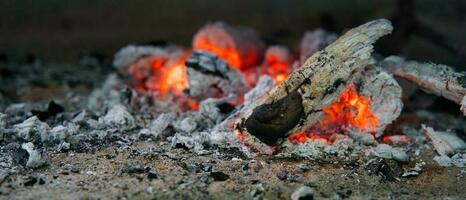 cendres et rouge flammes à l'intérieur brûlant bois en dessous de barbecue gril, mahe les Seychelles photo