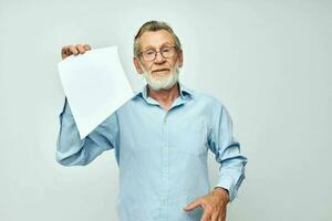 personnes âgées homme en portant une feuille de papier copie-espace posant isolé Contexte photo