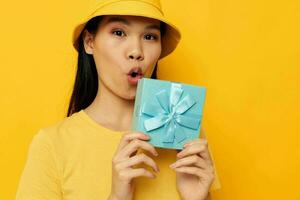 femme avec une cadeau boîte dans le sien mains surprise émotions studio modèle inchangé photo