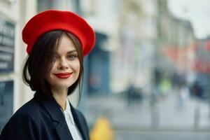 mode femme sourire printemps en marchant dans le ville dans élégant vêtements avec rouge lèvres et rouge béret, voyage, cinématique couleur, rétro ancien style, Urbain mode mode de vie. photo