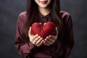 photo de foncé rouge un cœur dans fille main concentrer de cœur. valentines journée concept. génératif ai