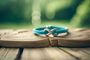 une proche en haut photographier de une paire bleu bracelet formant un infini symbole sur une rustique bois avec bokeh Contexte photo