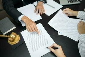 le conseiller juridique présente au client un contrat signé avec le marteau et la loi légale. concept de justice et d'avocat photo