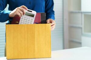 quitter emploi affaires homme Envoi en cours démission lettre et emballage des trucs démissionner déprimer ou porter affaires papier carton boîte dans bureau. changement de emploi ou mis à la porte de entreprise. photo