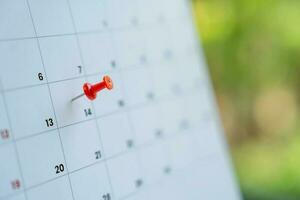 rouge pousser épingle sur calendrier 14e journée de le mois, marque le un événement journée avec une broche. photo