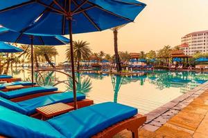 beau parasol et chaise autour de la piscine de l'hôtel et du complexe photo