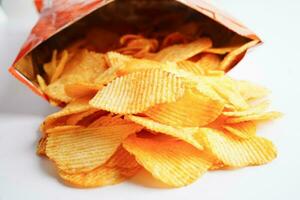 croustilles de pommes de terre dans un sac ouvert, délicieux assaisonnement pour barbecue épicé pour les frites, collations frites en tranches fines de restauration rapide. photo