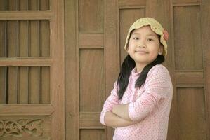 mignonne asiatique fille sourire sur vieux bois arrière-plan, photo