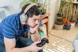 malheureux Jeune caucasien homme en jouant vidéo Jeux ennui. photo