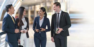 les gens d'affaires se tiennent debout et se parlent devant un bureau moderne photo