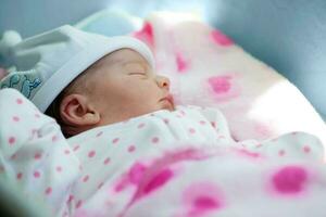 nouveau née fille dans le hôpital sur le journée de sa naissance photo