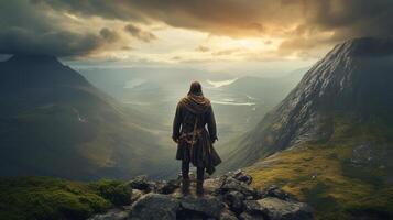 ai génératif une encapuchonné guerrier homme des stands un haut une robuste Montagne de pointe photo