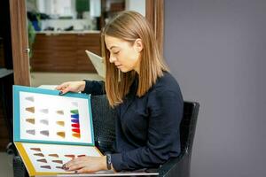 Jeune caucasien femme choisir une Couleur de le cheveux Couleur graphique dans une beauté salon. photo