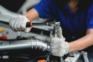 mécanicien vérification moteur pétrole dans auto réparation magasin. fermer de une mécanicien réparer un moteur dans une garage. mécanicien dans une voiture réparation un service centre. photo