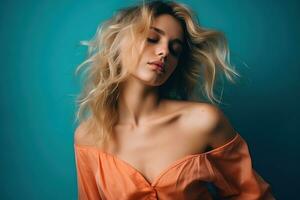 portrait de Jeune jolie blond femme dans lumière Orange robe dans studio avec turquoise Contexte. ai généré photo