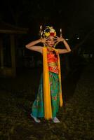 une Javanais Danseur pose avec tranchant yeux et une d'or costume sur étape photo