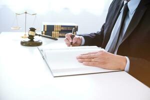 le conseiller juridique présente au client un contrat signé avec le marteau et la loi légale. concept de justice et d'avocat. photo