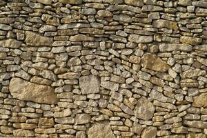 une mur fabriqué de pierre avec beaucoup différent formes photo