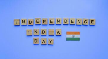 août 15, indépendance journée dans Inde, drapeau de Inde, minimaliste bannière avec le une inscription dans en bois des lettres sur une bleu Contexte photo