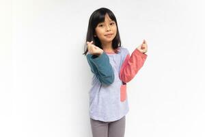 une mignonne sur de soi fille élevé sa mains à spectacle l'amour signe geste de coréen culture , saranghae main geste photo
